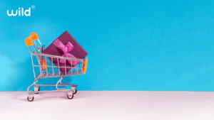 Shopping trolley with pink Christmas gift 